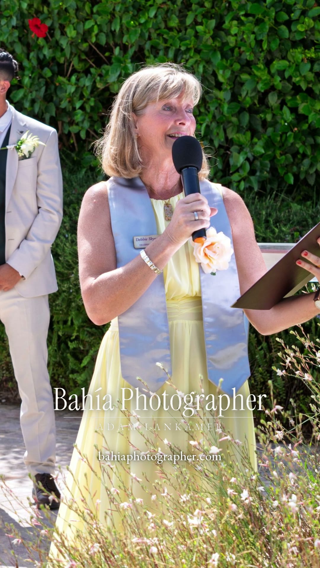 Reel — the celebrant speaking at a garden wedding ceremony as the bride wipes away a tear